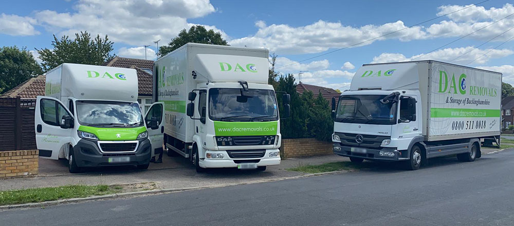 DAC Removals' vehicles parked outside of a house